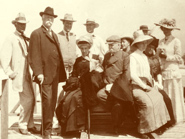 Group of possible hotel guests waiting on Naples Pier for passenger boat to Fort Myers.  Pictured William Haldeman (2nd from left); George Hendrie (3rd from left); John Hachmeister (5th from left). March 27, 1912. (John Hachmeister Collection)