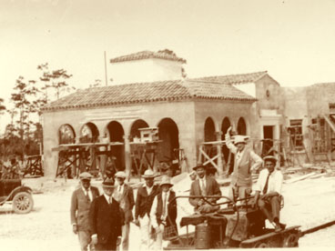 View of unfinished Seaboard Air Line Railroad station, Naples Depot.  Group of people clustered on handcar.  William Cambier (extreme left); C.H. Maxleg (2nd from left); Jim Hamill (extreme right).  (John Hachmeister Collection)