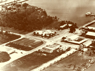 Aerial view of Naples back bay area (Crayton Cove) and City Dock showing Collier County News building on 12th Avenue South. C. 1955.  Old Cove Restaurant in center corner on 8th Street owned by Benny Morris, formerly the White Pelican Restaurant.