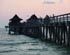 Residents and visitors walk on the Naples Pier at sunset.